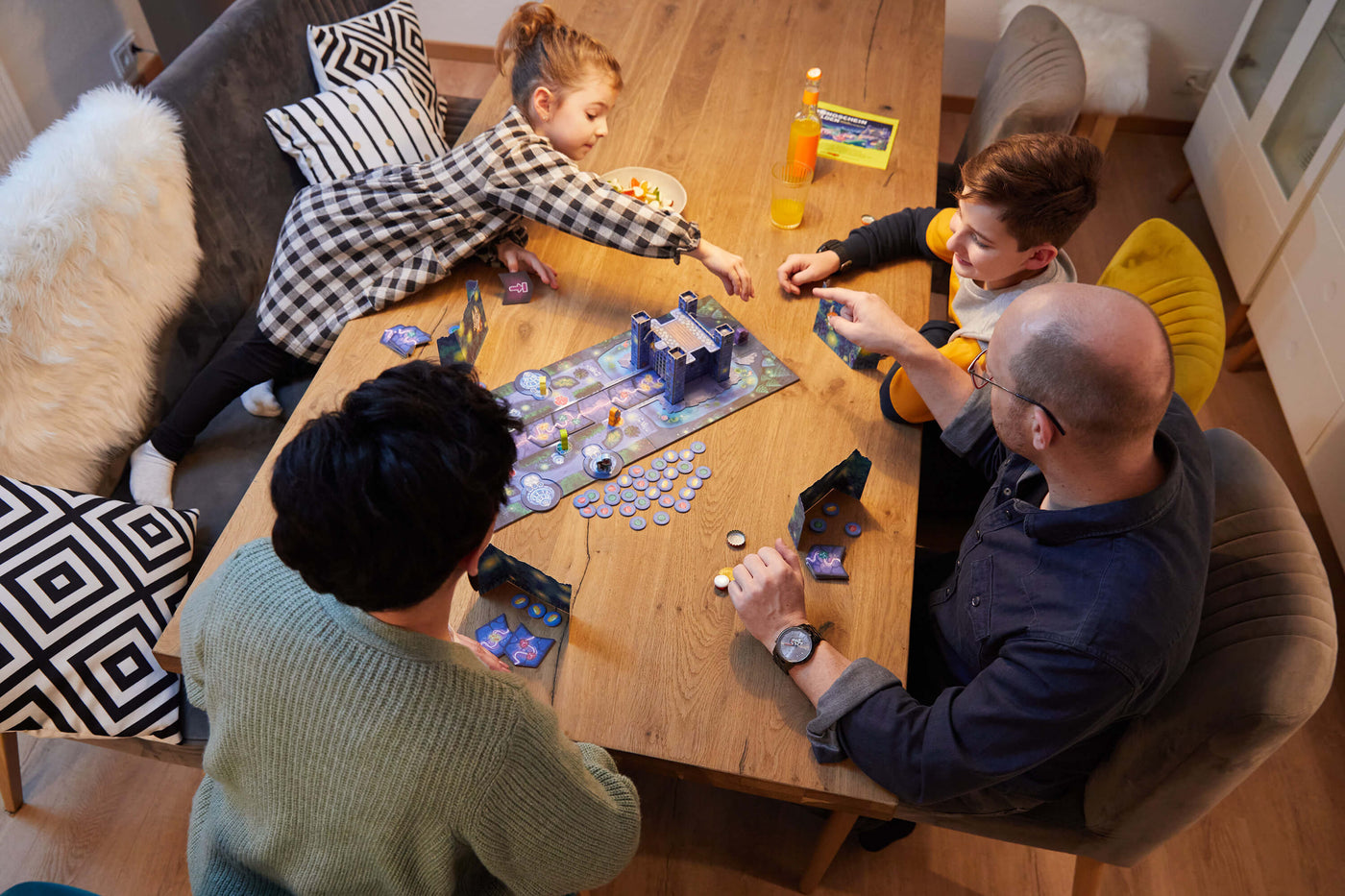 parents and children playing a board game