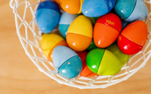 Overhead view of HABA Wooden Musical Eggs in a wire basket