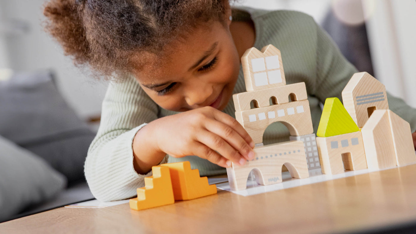 Girl playing with Logical Master Builder Blocks