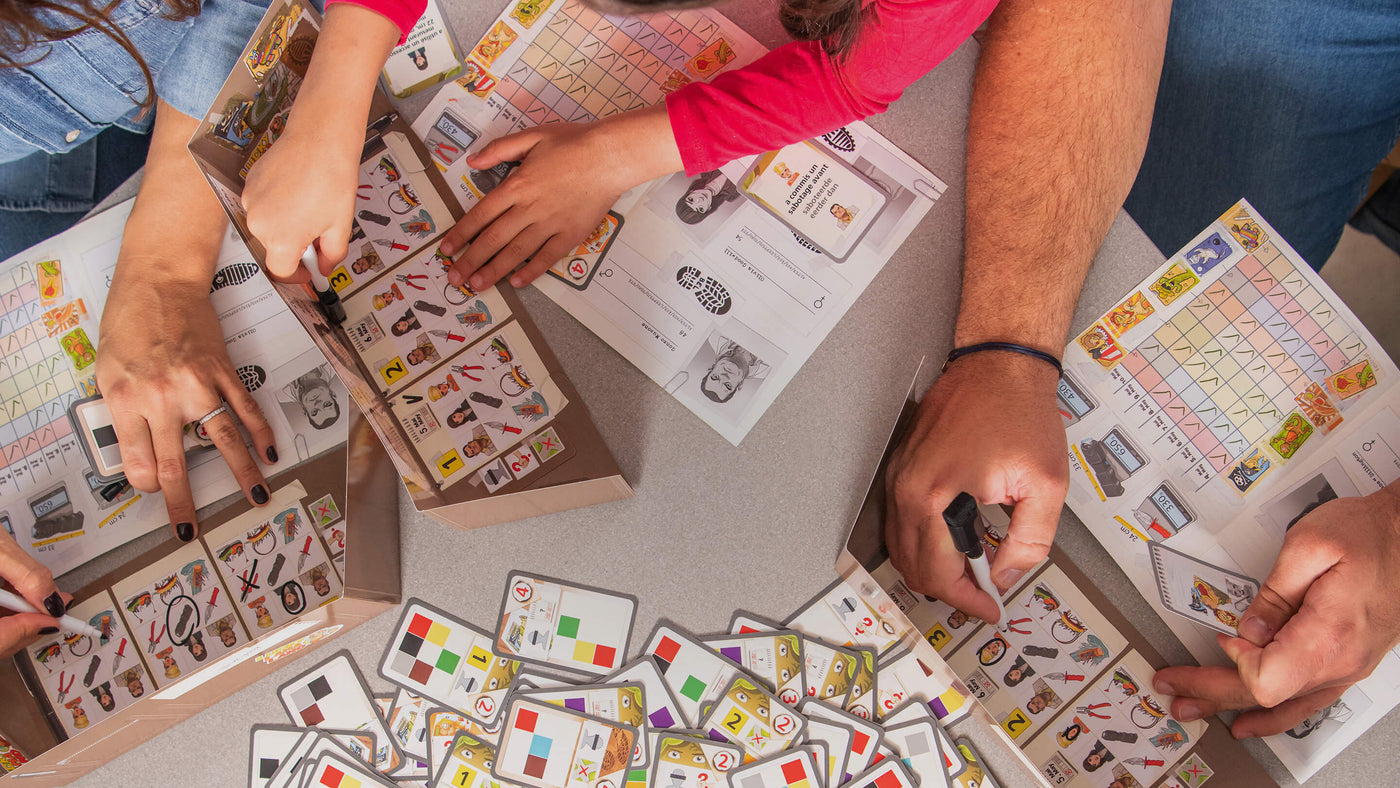 Overhead perspective on hands playing HABA: The Key Lucky Llama