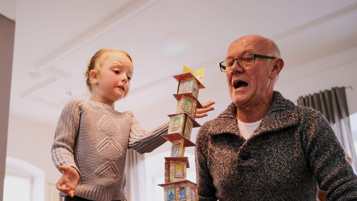 Granddaughter and grandpa playing  Rhino Hero