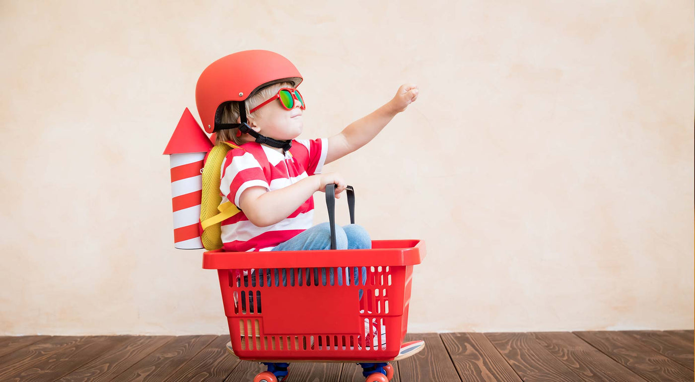 A young boy is dressed as a superhero.