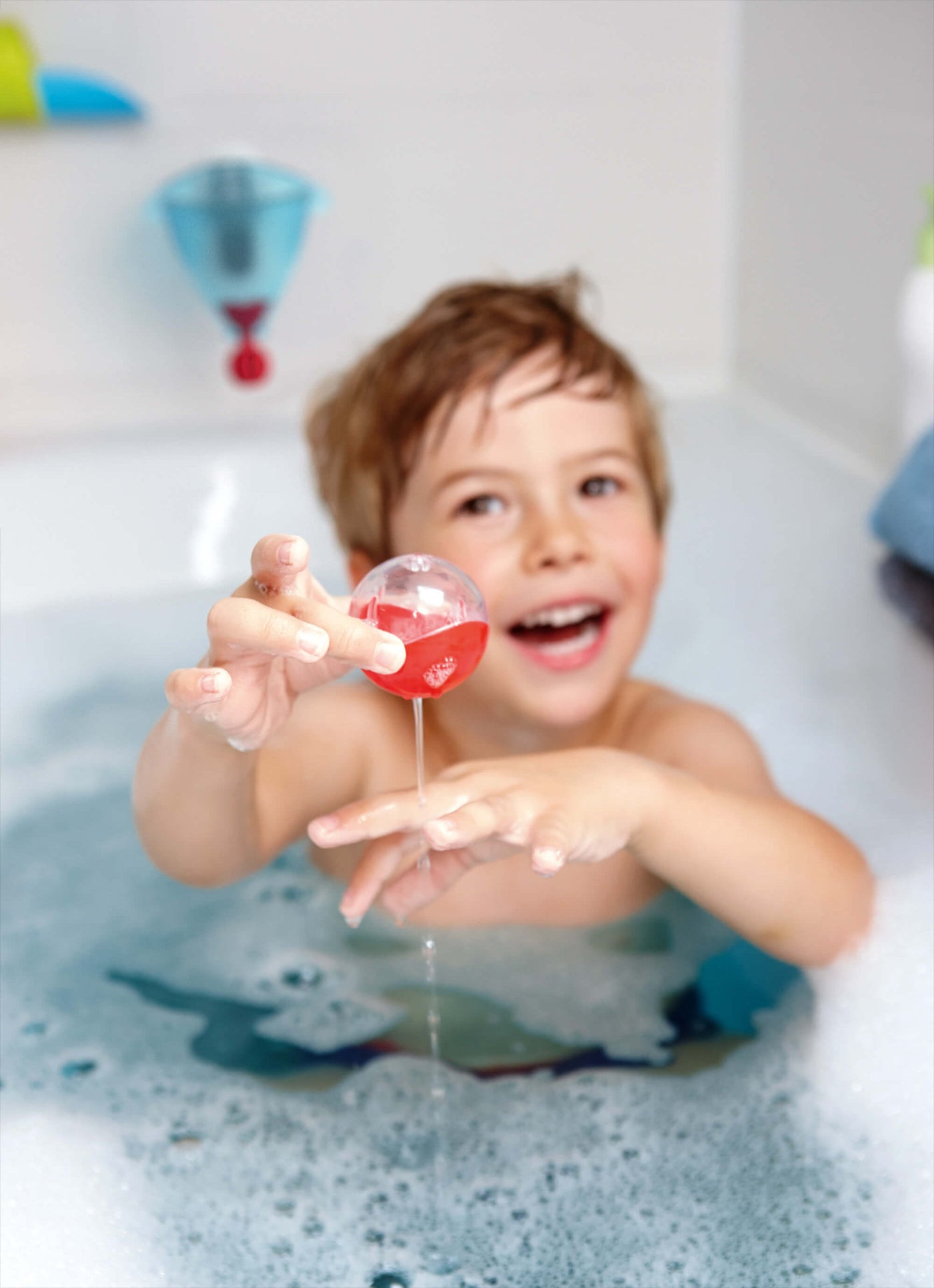 child playing with a ball in the bath