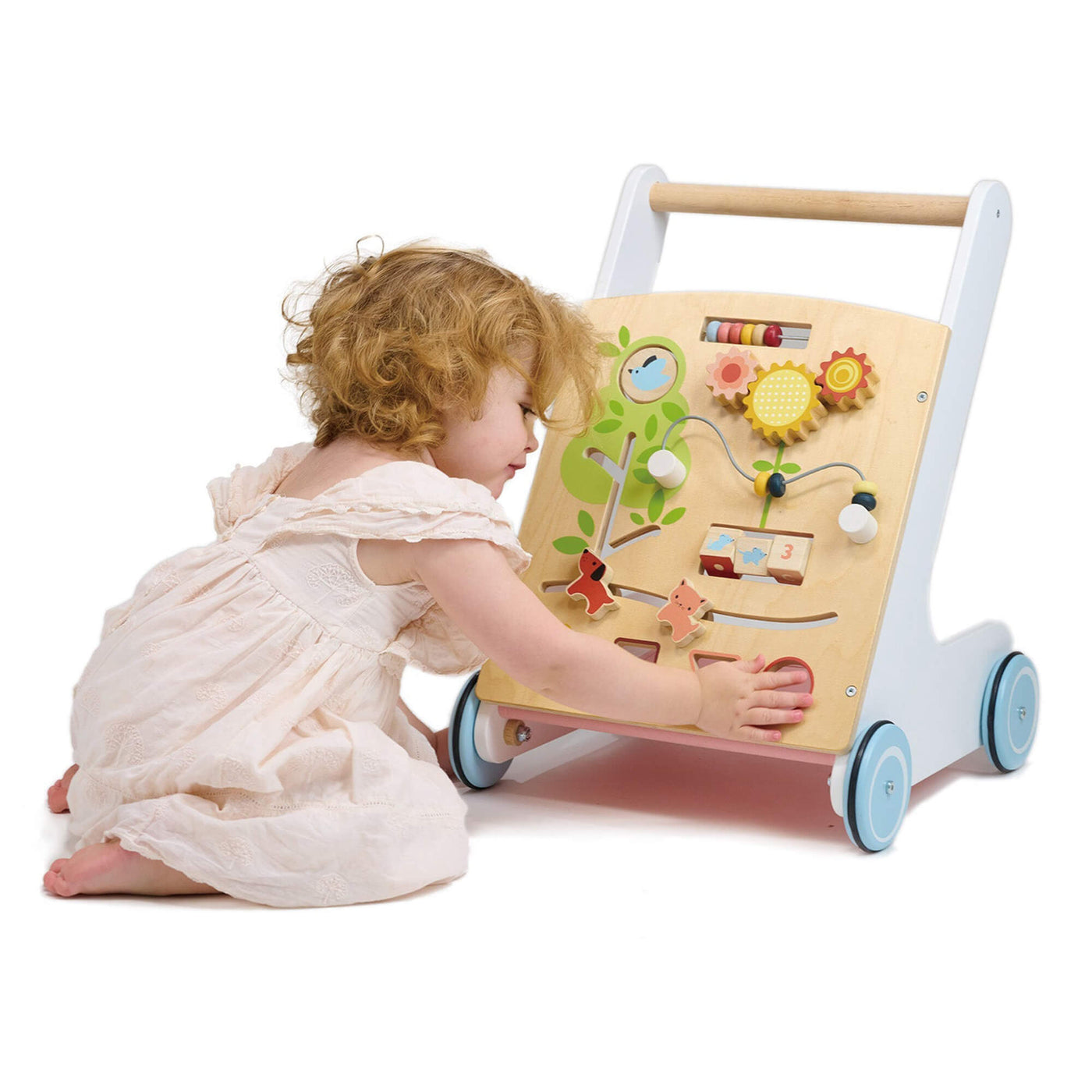 Child playing with a wooden educational push toy on a white background