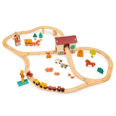 Wooden toy train set with tracks, houses, and animals on a white background