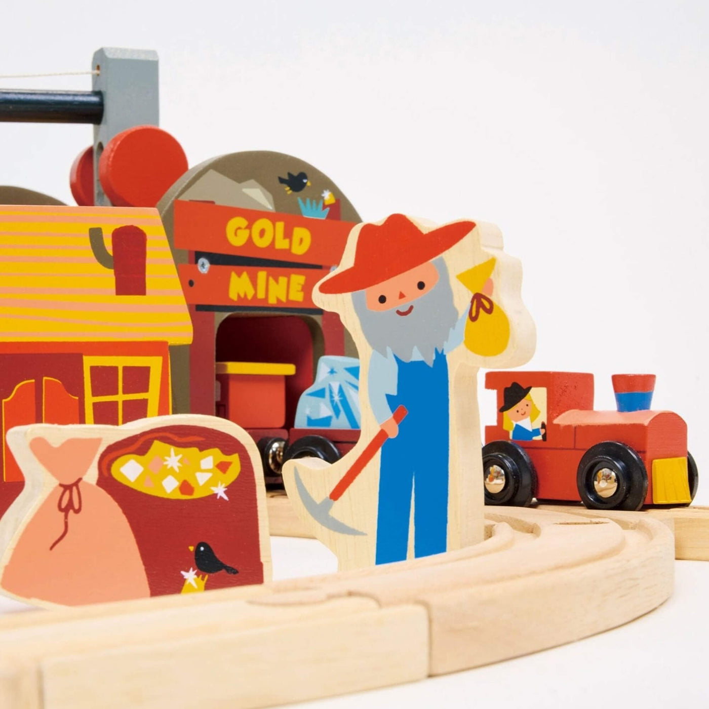 Wooden toy set with a gold mine scene, including a character with a pickaxe and a train.