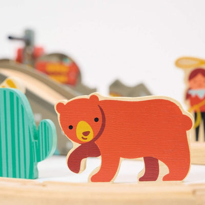 Wooden bear toy figure on a playset with blurred background