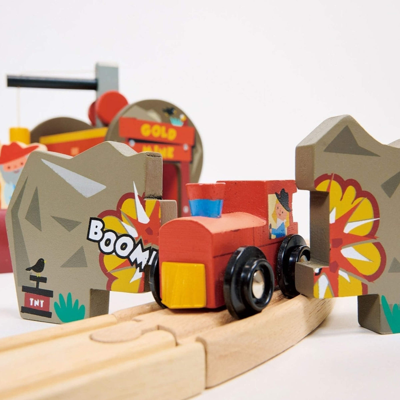 Wooden toy train set with colorful track and cartoonish BOOM design elements on a white background