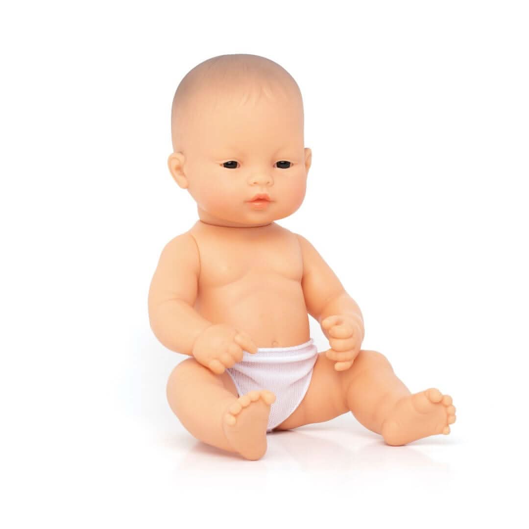 A Miniland 12-inch Realistic Montessori Asian Girl Baby Doll. Anatomically correct and designed for inclusive, educational play.