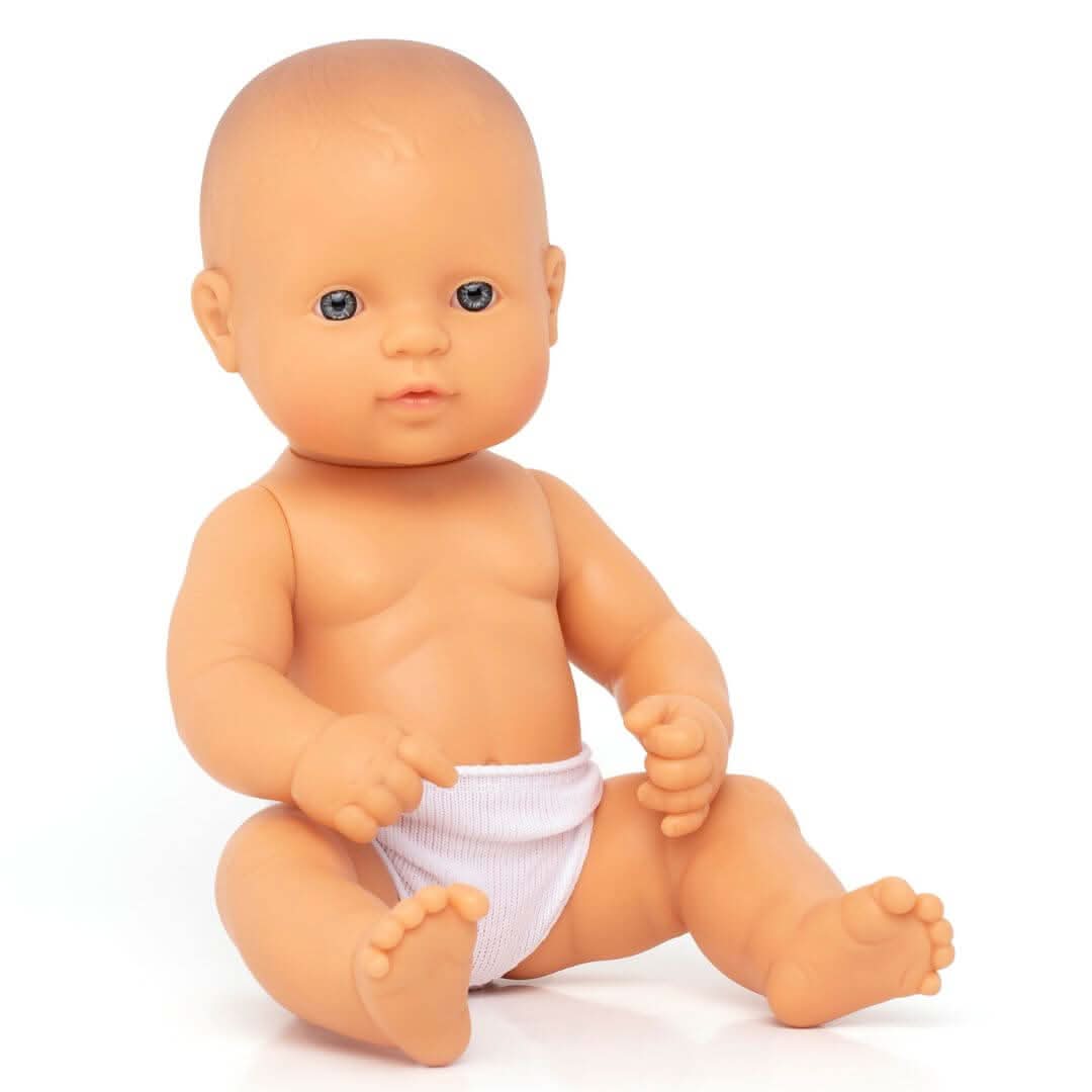 A Miniland 12-inch Realistic Montessori White Girl Baby Doll.  Anatomically correct and designed for inclusive, educational play.