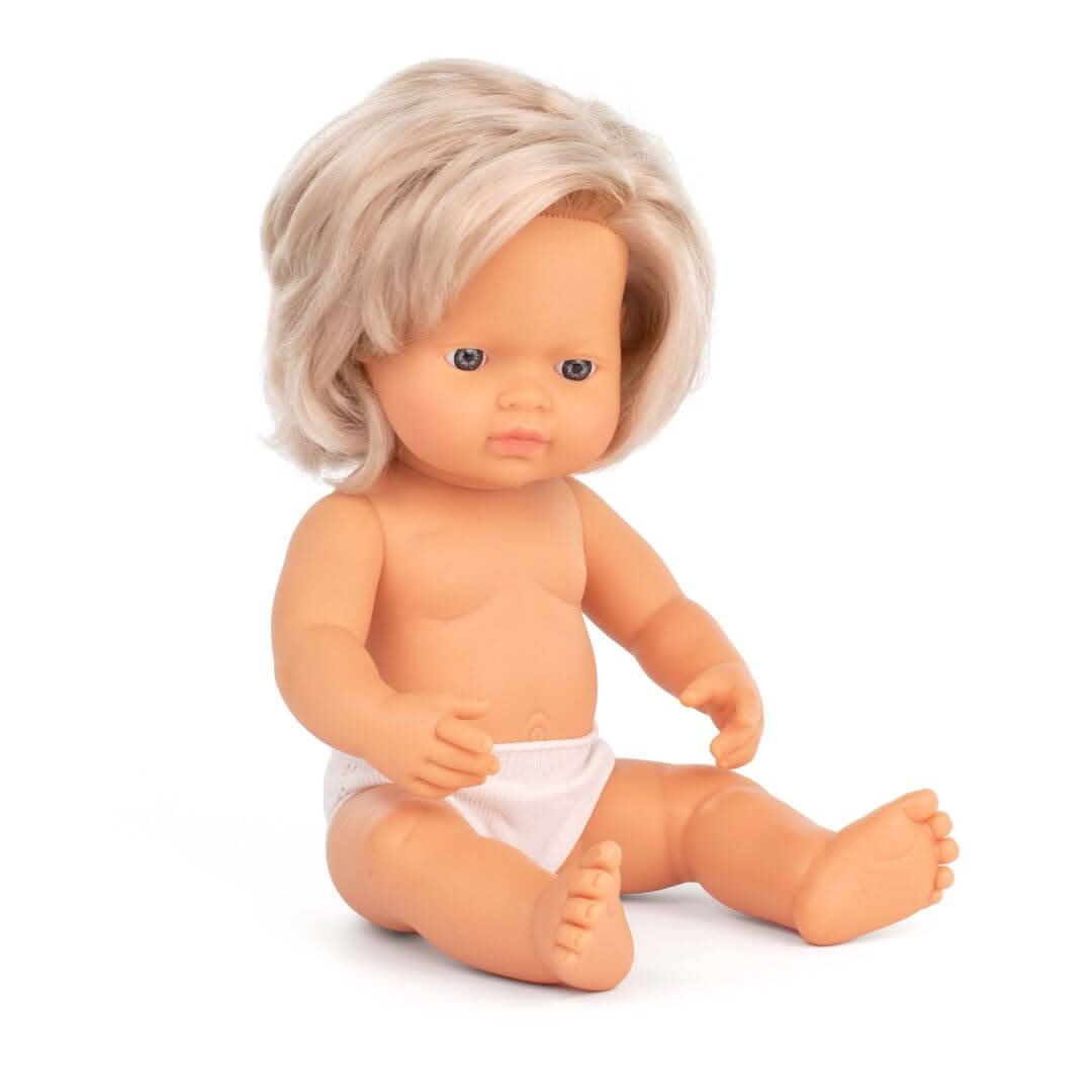 A 12-inch Miniland Realistic Montessori Baby Doll – Blond-haired Girl, anatomically correct details, and soft vinyl construction. Designed for inclusive, educational play.