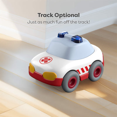 Toy car with red and white ambulance design on a wooden floor with text 'Track Optional. Just as much fun off the track!'.