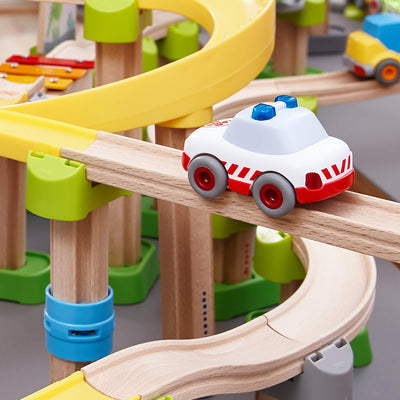 Toy car on a wooden track with colorful accessories