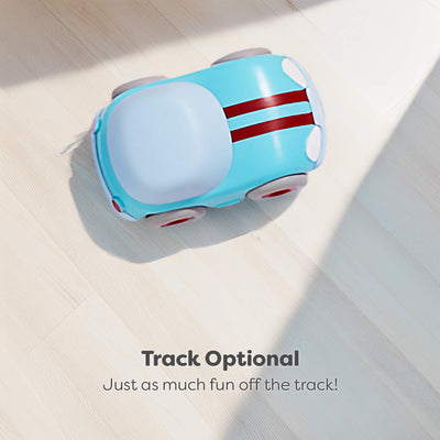Toy car with blue body and red stripe on a light surface, text 'Track Optional. Just as much fun off the track!' below.
