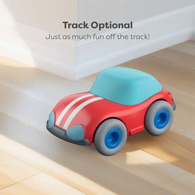 Toy car with a blue roof on a wooden floor, text 'Track Optional. Just as much fun off the track!' above.