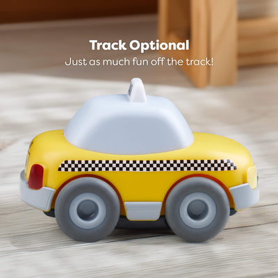 Toy taxi with checkered pattern on a wooden surface, text 'Track Optional Just as much fun off the track!'.