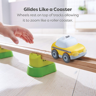 Toy taxi car on a track with text describing that it sits on top of the track so it glides like a roller coaster