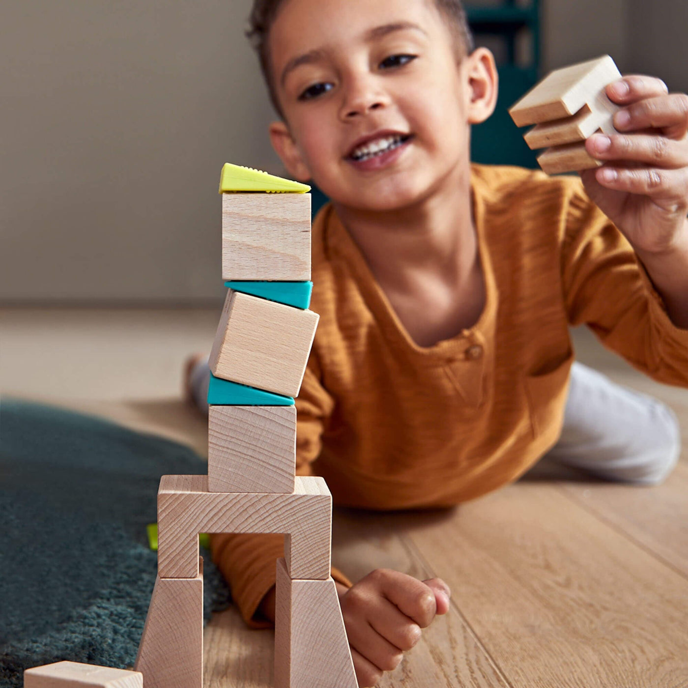 Child playing with Crooked Tower Wooden Blocks - HABA USA