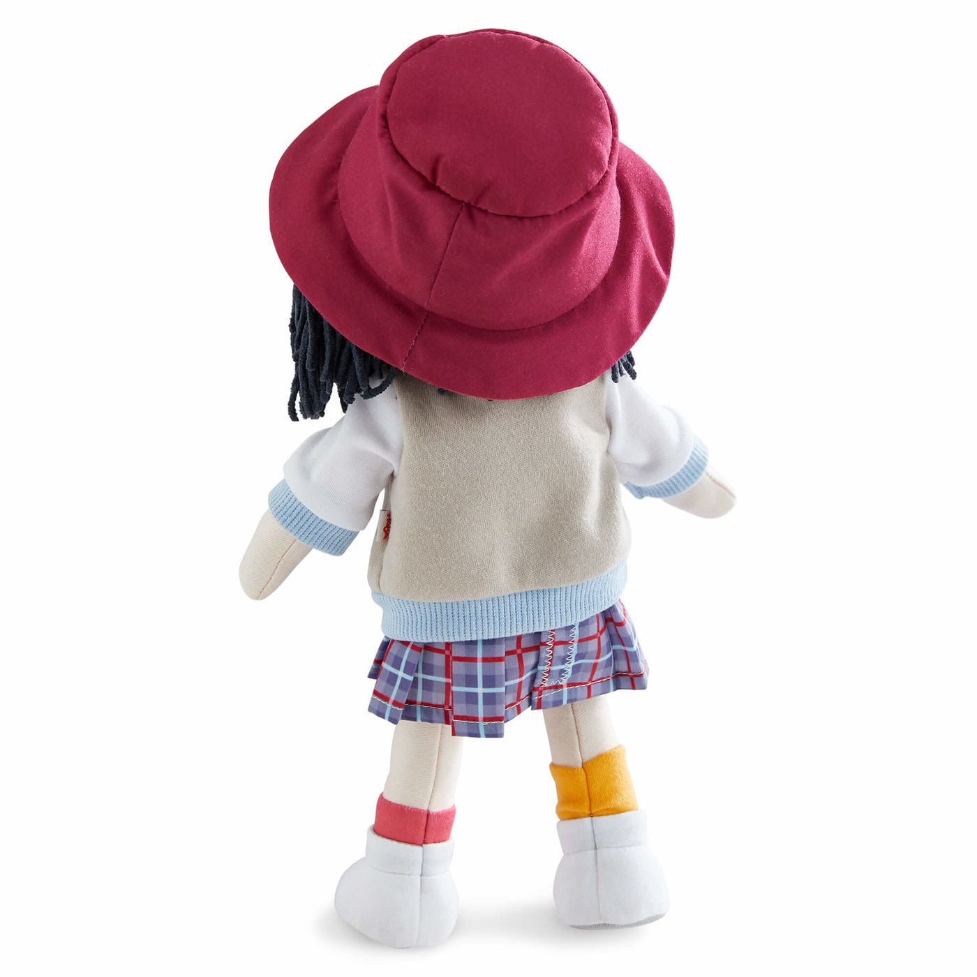 Back of Yuki fabric doll with a red hat, tan jacket, plaid skirt, and mismatched socks.