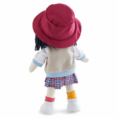 Back of Yuki fabric doll with a red hat, tan jacket, plaid skirt, and mismatched socks.