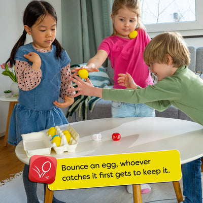 Children playing Dancing Eggs with bouncy eggs on a table, with a text box explaining the rules.