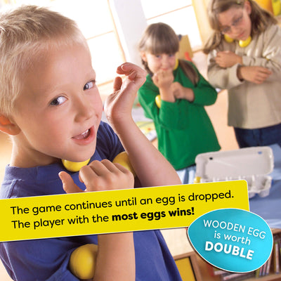 Children playing a game with eggs in a classroom setting. Text overlay says "The game continues until an egg is dropped. The player with the most eggs wins!"