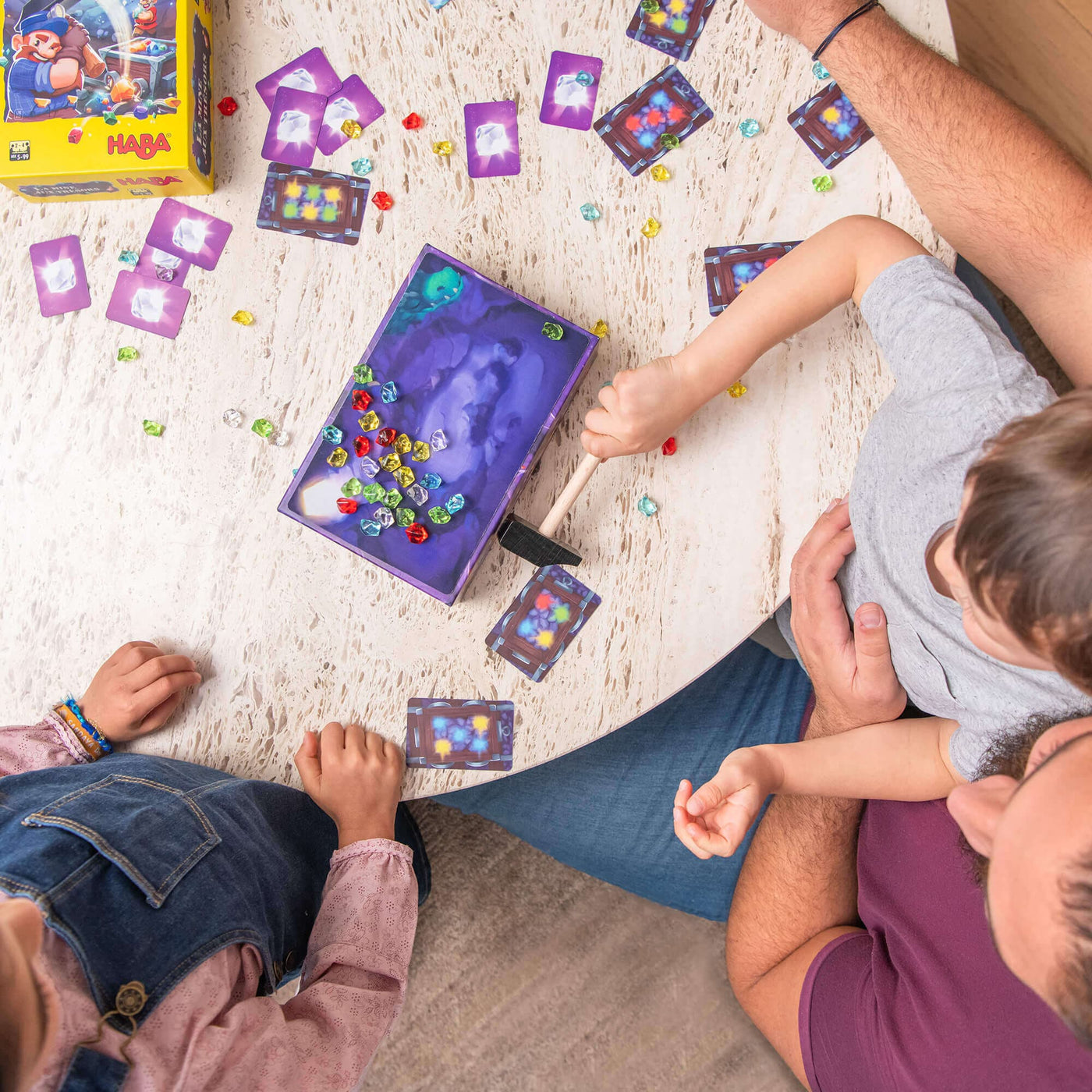 Family playing HABA Hammer Time game on wooden table