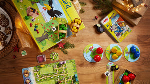 Orchard, First Orchard, Karuba, and Rhino Here games on a wooden table