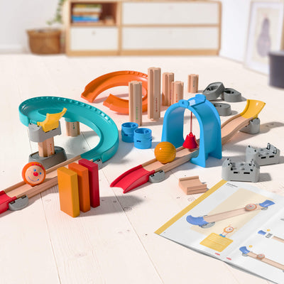 Kullerbu Colorful Curves - Build & Grow Ball Track Set on a light wooden floor with a white wall background