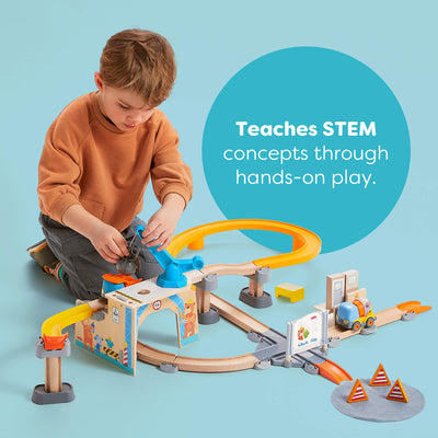 Child playing with a toy track set on a blue background, with text about teaching STEM concepts.