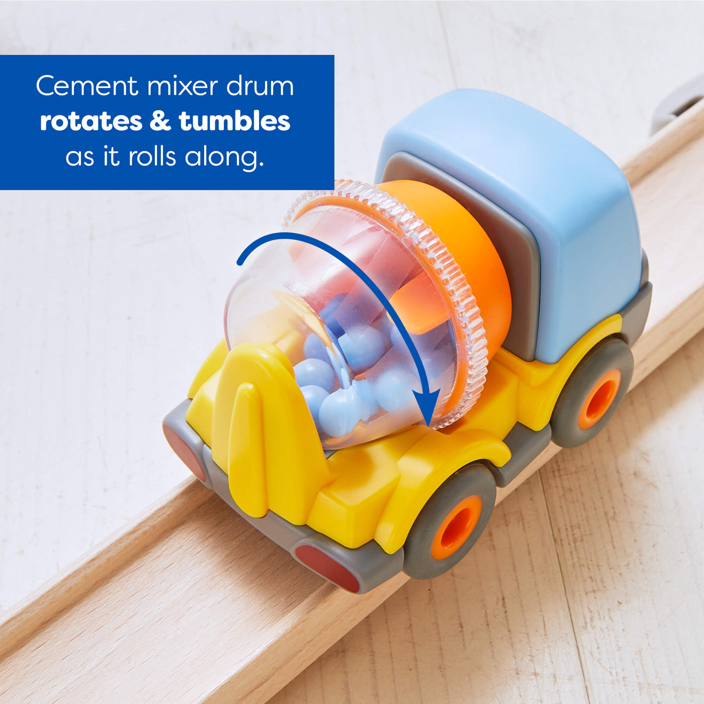 Toy cement mixer with rotating drum on a wooden track