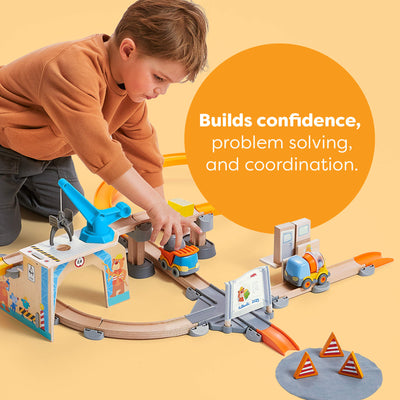 Child playing with a toy train set on a yellow background with text about building confidence, problem solving and coordination.