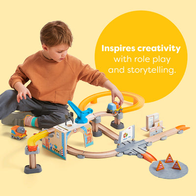 Child playing with a toy train set on a yellow background with text about inspiring creativity with role play and storytelling.