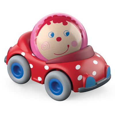Toy car with a wood ball with a smiling face sitting in it