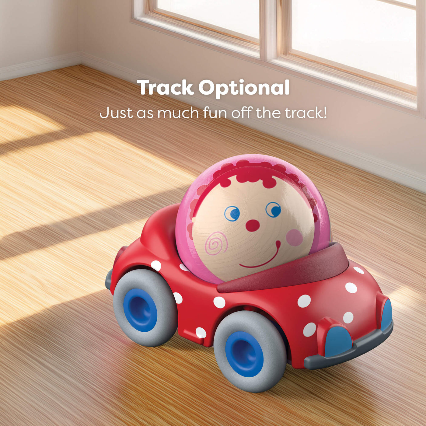 Toy car with a ball inside on a wooden floor, with text 'Track Optional' above.