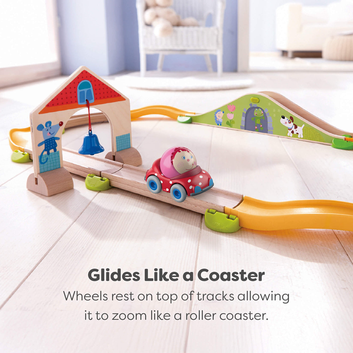 Kullerbu track set with a car on a light wooden floor.