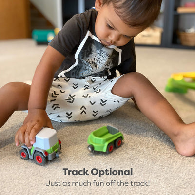 Child playing with toy cars on a carpeted floor with text 'Track Optional' and 'Just as much fun off the track!'.