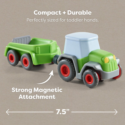 7.5" Toy tractor with trailer on a beige background, highlighting compact size and magnetic attachment.