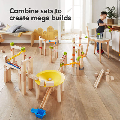 Combine sets to create mega builds! Child playing with marble track sets