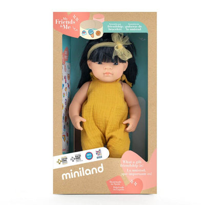 A 14-inch Miniland Asian Doll from the My Friends & Me Collection in the packagin that it arrives in, featuring realistic details, soft vinyl construction, and designed to promote friendship and inclusivity.