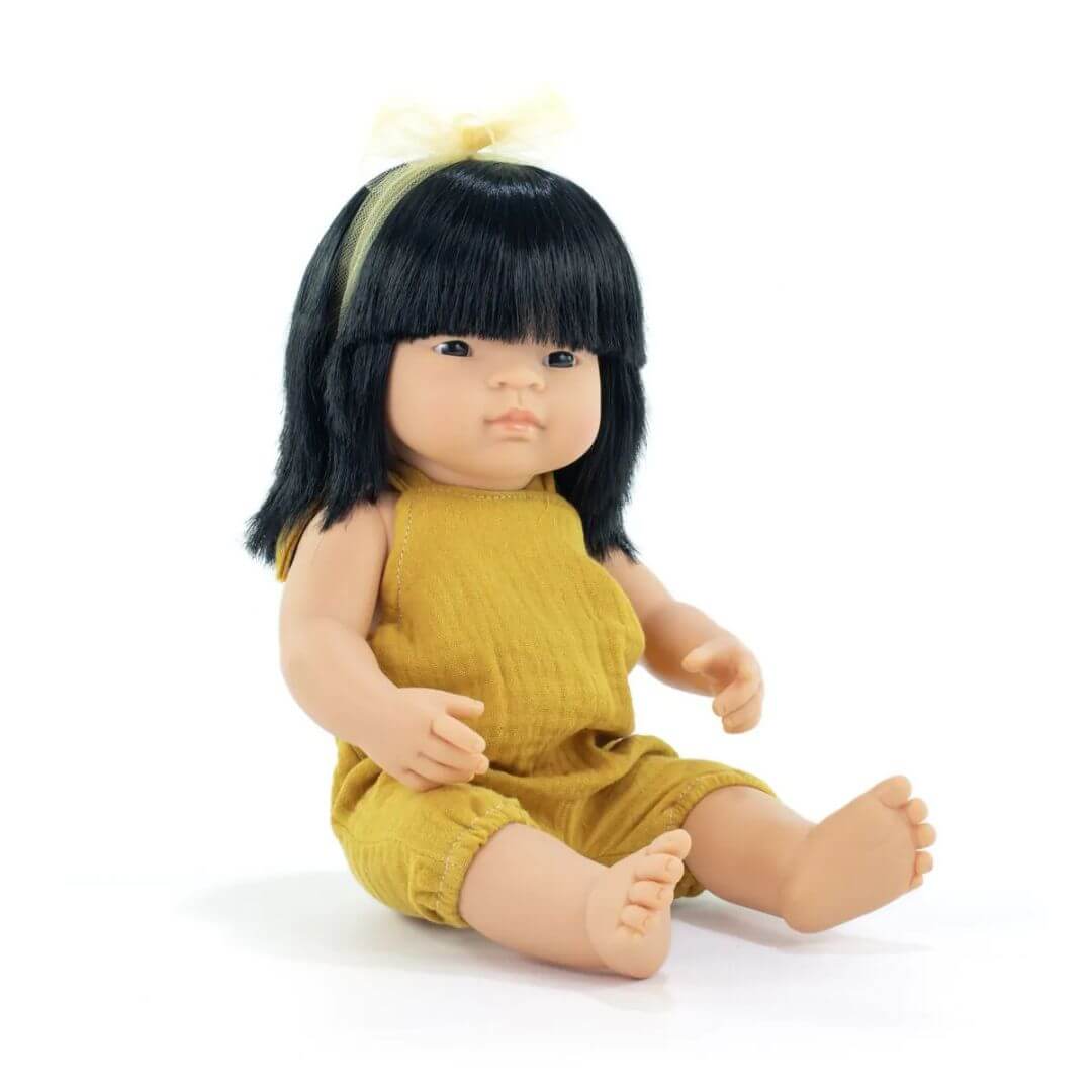 A 14-inch Miniland Asian Doll from the My Friends & Me Collection, featuring realistic details, soft vinyl construction, and designed to promote friendship and inclusivity.