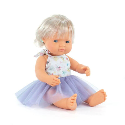 Miniland Montessori doll with blonde hair and visible cochlear implant, wearing a floral top and lavender tulle skirt, seated on a white background.