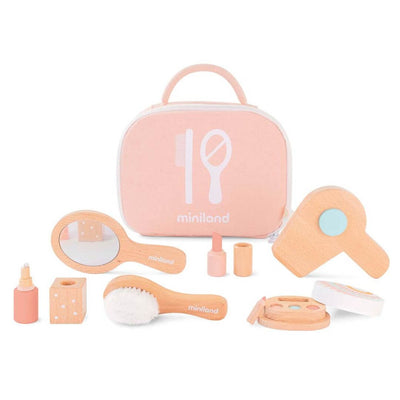 A beautifully crafted wooden doll beauty set by Miniland, made from FSC-certified sustainable wood. Includes a mirror, brush, hairdryer, makeup compact, lipstick, and carrying case in soft, natural tones.