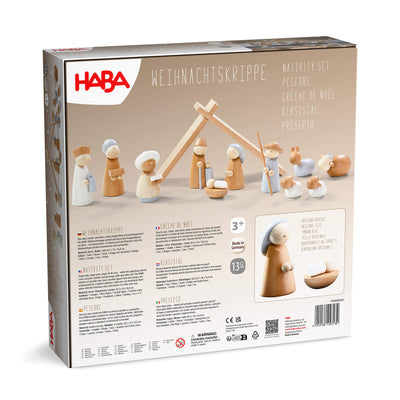 HABA Nativity set back of packaging with wooden figures and stable on a beige background