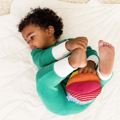 Baby playing with Rainbow Fabric Baby Ball