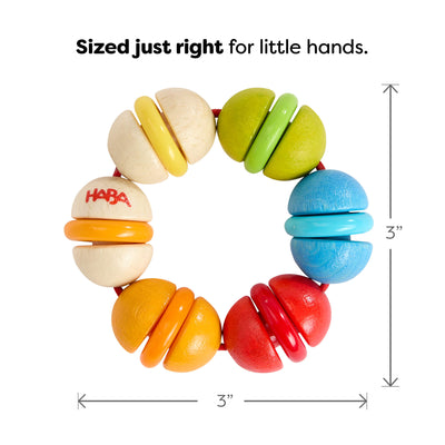 Rainbow Rattle Grasping and Teething Toy wooden teething ring with HABA logo and 3" measurements on a white background, text reads 'Sized just right for little hands'