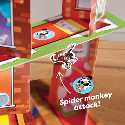 Close up of monkey game piece hanging off the Rhino Hero Super battle card tower with the words "Spider monkey attack!"