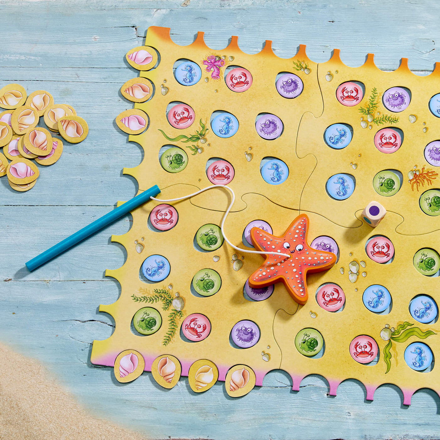 HABA Sebastian Seastar children's fishing game with starfish and colorful tiles on a wooden surface