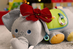HABA Elephant Discovery Pillow with a red bow under a Christmas tree