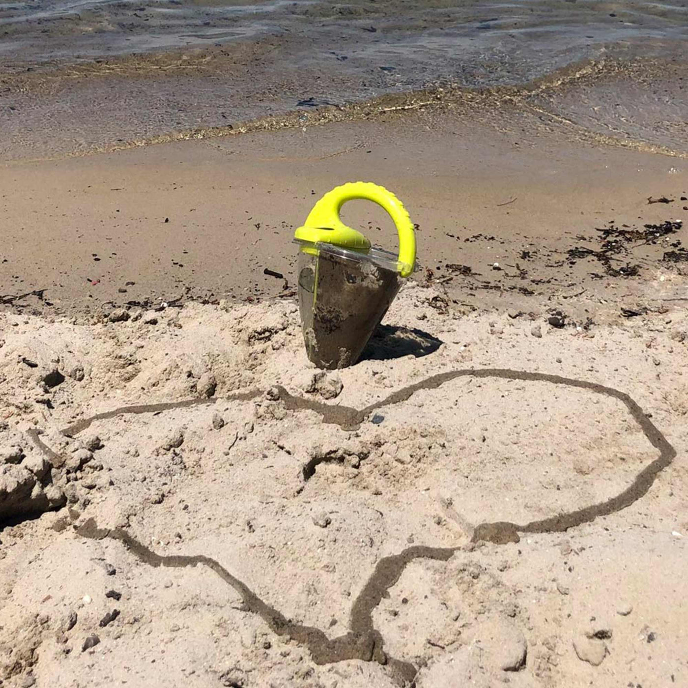 HABA Spilling Funnel Sand Toy with a heart in the sand